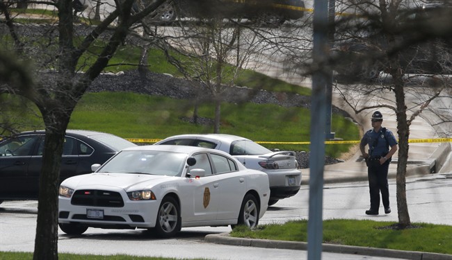 A Kansas State Trooper stands near the location of a shooting at the Jewish Community Center in Overland Park, Kan., Sunday, April 13, 2014. 