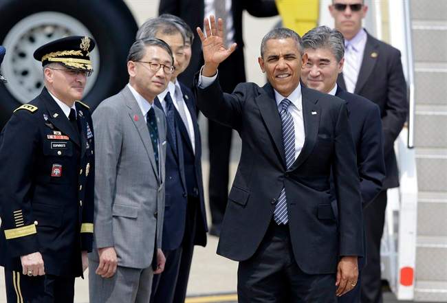 U.S. President Barack Obama waves upon his arrival for two-day visit at Osan Air Base in Pyeongtaek, south of Seoul, South Korea, Friday, April 25, 2014. 