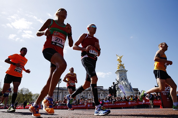 Runners pass Buckingham Palace during the London Marathon  on April 13, 2014 in London, England.