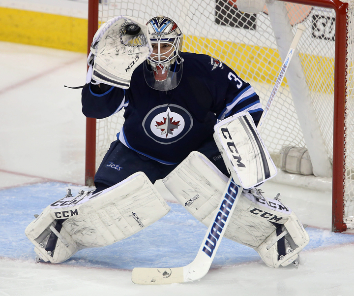 In his first NHL start, Winnipeg Jets goaltender Michael Hutchinson makes a glove save against the Minnesota Wild at the MTS Centre in Winnipeg on Monday. 