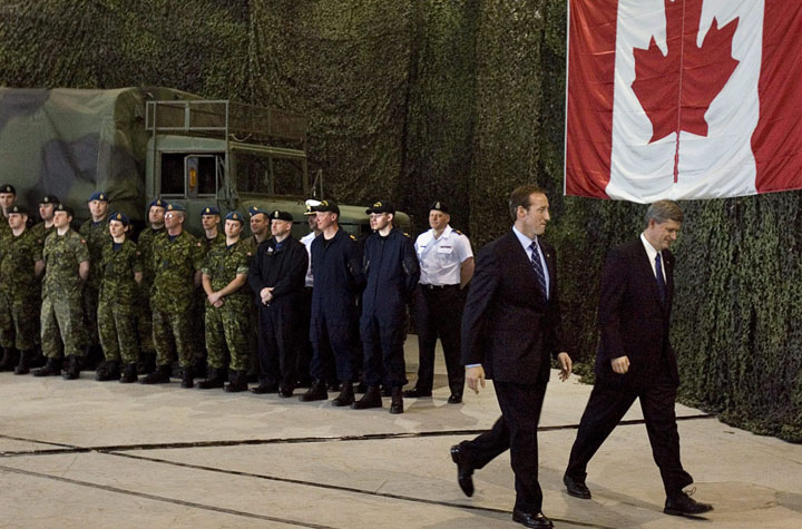 File - Prime Minister Stephen Harper, right, accompanied by Defence Minister Peter MacKay heads from a military spending announcement at the Halifax Armoury in Halifax on Monday, May 12, 2008. 