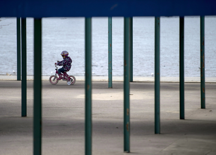 A child rides a bicycle at Mooney's Bay Park in Ottawa on Sunday, April 20, 2014. 