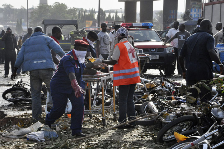 Rescue workers work to recover victims at the site of a blast at the Nyanya Motor Park, about 16 kilometers from the center of Abuja, Nigeria, Monday, April 14, 2014. 