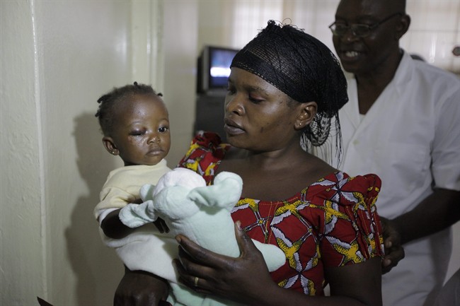 Goodness Adams, left, a 10-month baby, who survived Monday's bomb explosion is carried by her aunt, Grace Sabo, at the Wuse hospital in Abuja, Nigeria, Wednesday, April 16, 2014.