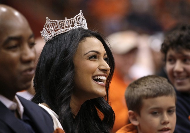 In this Saturday, Feb. 15, 2014, file photo, Miss America 2014 Nina Davuluri attends the NCAA college basketball game between Syracuse and North Carolina State in Syracuse, N.Y.
