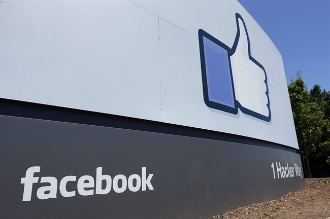 This Tuesday, July 16, 2013 file photo shows a sign at Facebook headquarters in Menlo Park, Calif. 