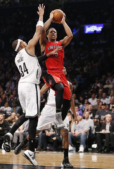 Brooklyn Nets forward Paul Pierce (34) defends against Toronto Raptors guard DeMar DeRozan (10) as DeRozan goes up for a layup in the first half of Game 4 of an NBA basketball first-round playoff series at the Barclays Center, Sunday, April 27, 2014, in New York.