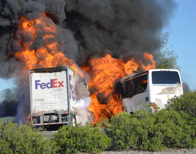 In this Thursday, April, 10, 2014, file photo, massive flames engulf a tractor-trailer and a tour bus just after they collide on Interstate 5, near Orland, Calif. 