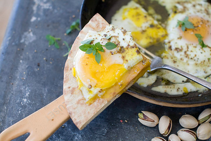 This photo shows oven eggs with olive oil and dukkah
