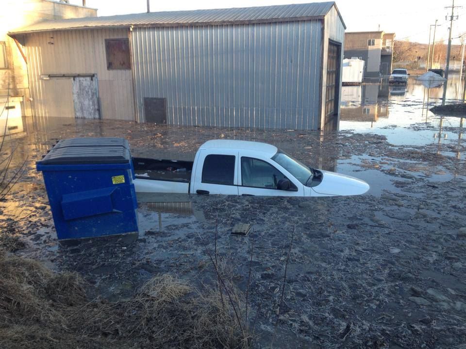 A truck is submerged under water after the town of Peace River, Alberta experiences flooding, Tuesday, April 8, 2014. 