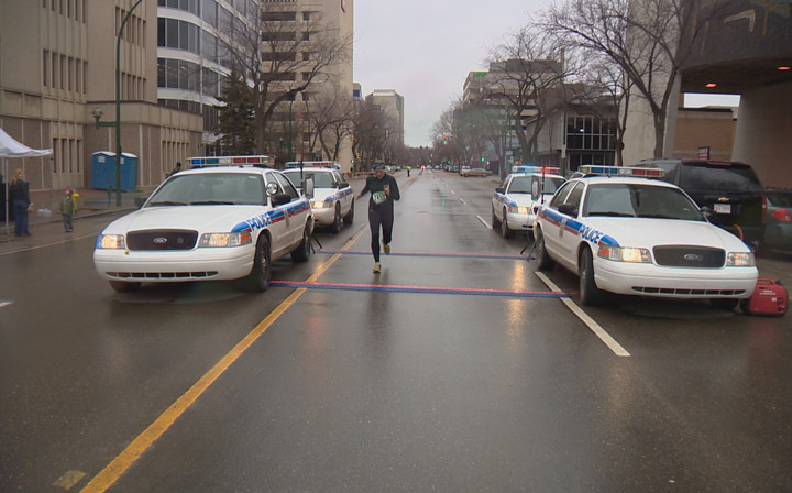 Saskatoon police officers, public lace up their running shoes for a rainy Sunday half marathon.