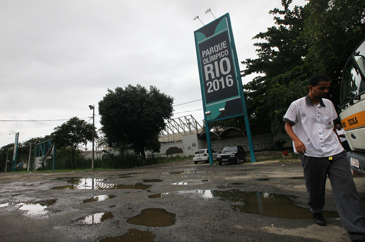 A man walks near the entrance to Olympic Park, the primary set of venues being built for the Rio 2016 Olympic Games, on April 16, 2014 in Rio de Janeiro, Brazil.