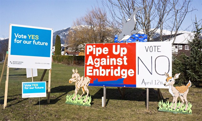 Competing campaign signs are seen in Kitimat, B.C. on Saturday, April 12, 2014, as voters cast their ballots in the town's plebiscite on the Northern Gateway pipeline project. A good turnout is expected as Kitimat residents express their opinion on the controversial project.