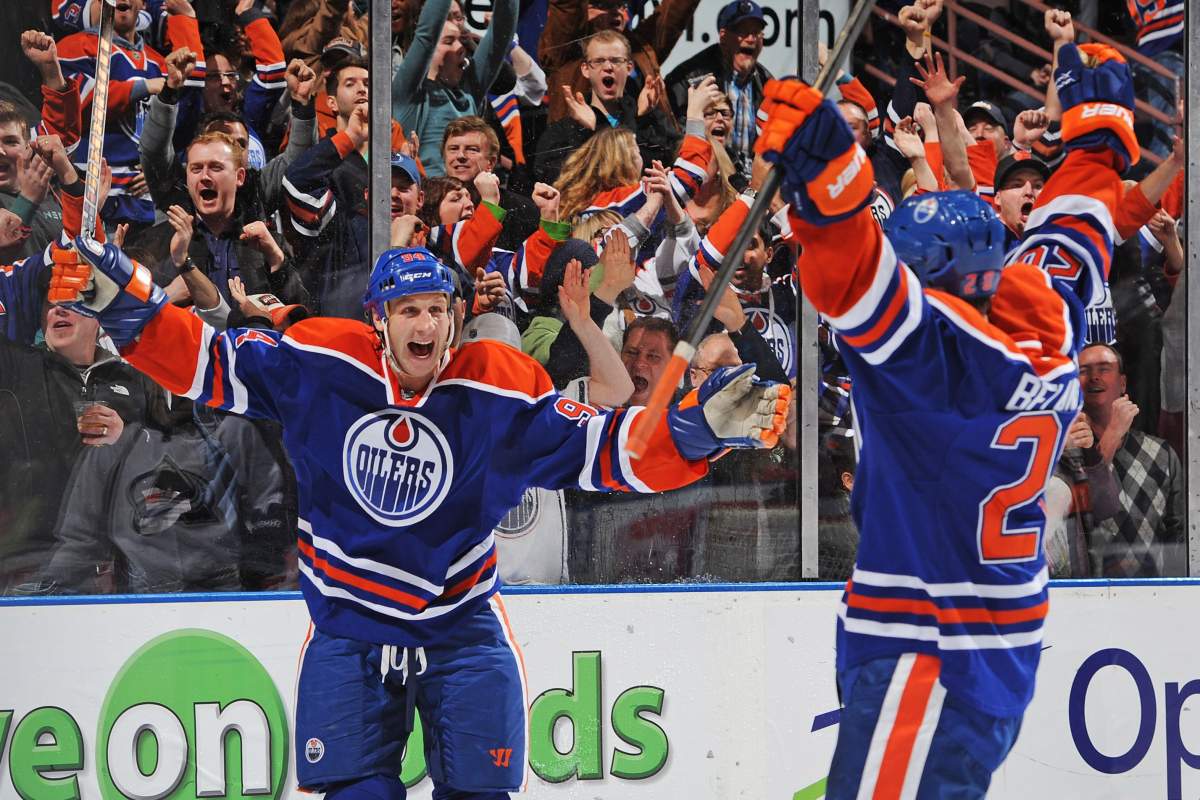  Ryan Smyth #94 of the Edmonton Oilers celebrates the goal of his teammate Magnus Paajarvi #91 (not pictured) on Semyon Varlamov #1 of the Colorado Avalanche during the NHL game at Rexall Place on February 16, 2013 in Edmonton, Alberta, Canada. Oilers won 6-4. 