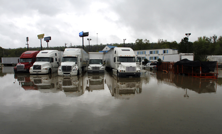 Several eighteen wheelers sit in a flooded parking lot after heavy rainfall caused major flooding on Monday, April 7, 2014, in Pelham, Ala.  