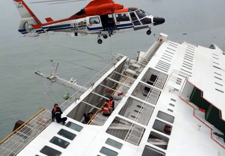 In this image taken from video released by News Y via Yonhap, passengers from a ferry sinking off South Korea's southern coast, are rescued by a South Korean Coast Guard helicopter in the water off the southern coast near Jindo, south of Seoul, Wednesday, April 16, 2014.