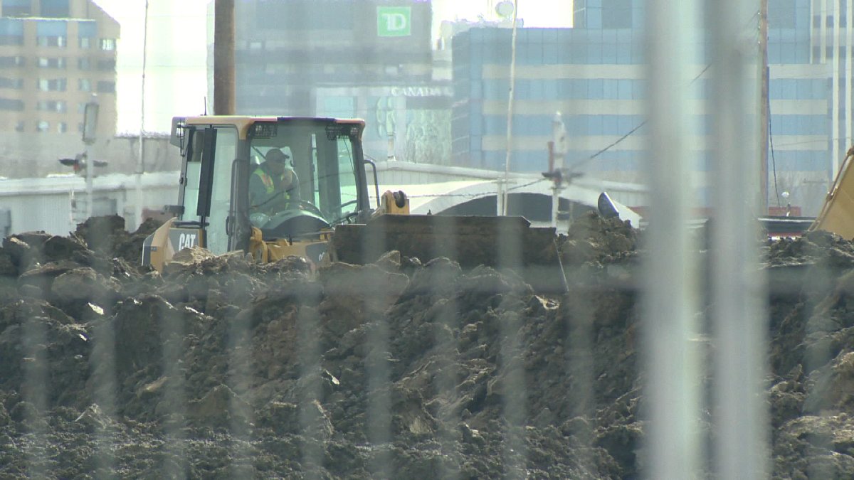Heavy machinery sets up at the site of Regina's new stadium.
