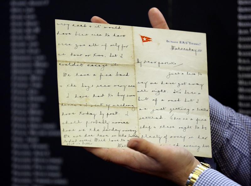 Auctioneer Andrew Aldridge of auctioneers Henry Aldridge & son holds a letter from Wallace Hartley, the band leader of the Titanic written aboard the doomed liner, which is being auctioned this week, on the 101st anniversary of the sinking of the ship on April 15, 2013 in Devizes, England.