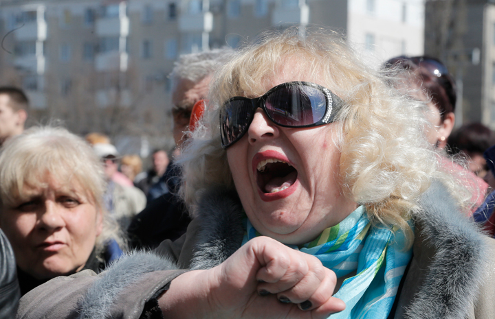 A Pro-Russian activist shouts during a rally in front of the regional administration building in Donetsk, Ukraine, Tuesday, April 8, 2014, as the makings of an improved self-appointed government began to take shape, with demonstrators dug in for their third day at the 11-storey regional administration headquarters. Ukrainian authorities on Tuesday reasserted control over an administration building in the country’s second-largest city of Kharkiv, 250 Km ( 155 miles) north of Donetsk, which had been seized by pro-Russian protesters, and authorities detained some dozens.