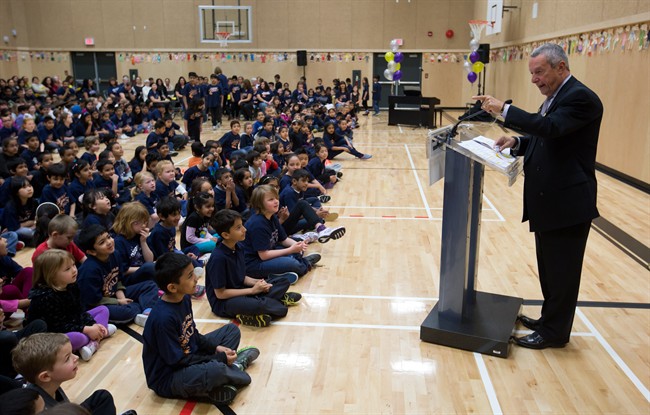 Students listen as British Columbia Minister of Education Peter Fassbender speaks at the official opening of Goldstone Park Elementary School in Surrey, B.C., on Thursday April 24, 2014. THE CANADIAN PRESS/Darryl Dyck.