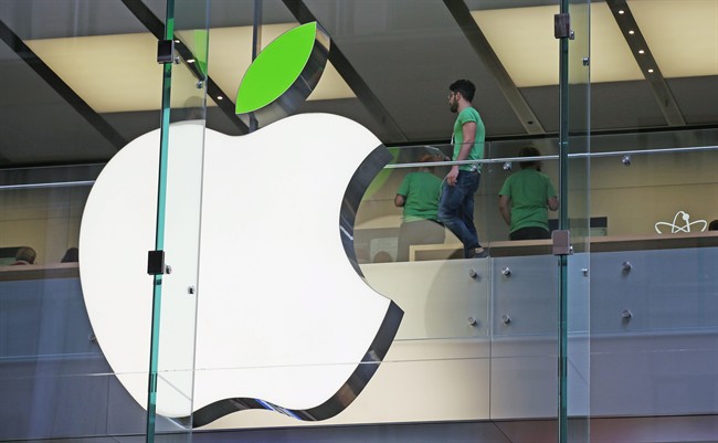 Employees wear green shirts near Apple's familiar logo displayed with a green leaf at the Apple Store timed to coincide with Tuesday's annual celebration of Earth Day in Sydney.