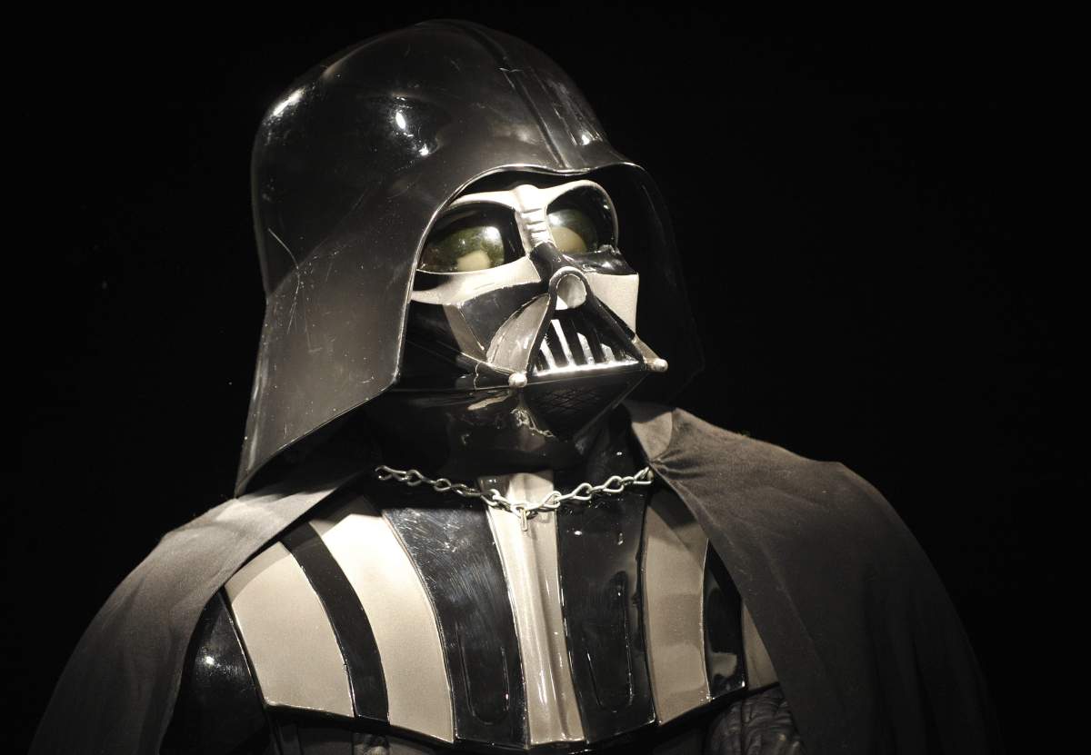 FILE - In this Oct. 27, 2010 file photo, a Darth Vader costume produced for the second Star Wars movie "The Empire Strikes Back," released in 1980, is on display at Christie's auction house in London. For Star Wars fans, there has been a lot of speculation about what direction the series will take ever since Disney announced in October 2012 that it would buy Lucasfilm for $4.05 billion and resume making “Star Wars” movies, starting with Episode 7 in 2015. (AP Photo/Lennart Preiss, File).