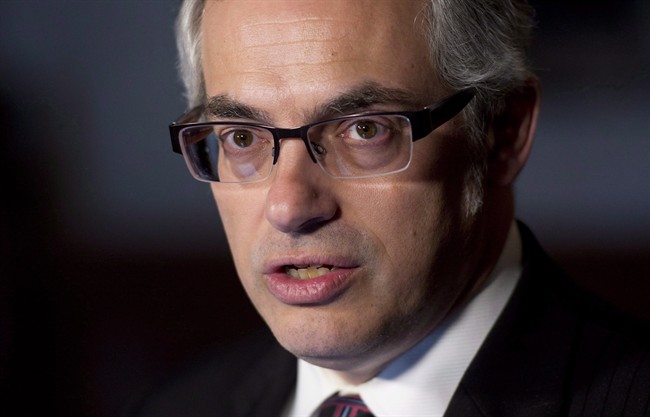 Treasury Board President Tony Clement speaks with the media about negotiations with the public service, Wednesday March 26, 2014 in Ottawa.The Conservative government has touted the thousands of databases it is making public as evidence of its openness and transparency. THE CANADIAN PRESS/Adrian Wyld.