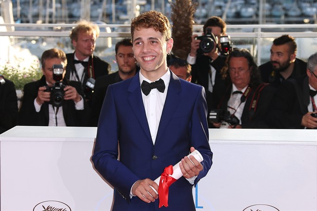 Director Xavier Dolan poses after winning the Jury Prize award in Cannes on May 24, 2014.