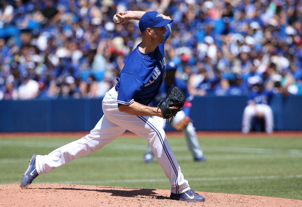 J.A. Happ #48 of the Toronto Blue Jays delivers a pitch in the fourth inning during MLB game action against the Oakland Athletics on May 25, 2014 at Rogers Centre in Toronto, Ontario, Canada. (Photo by Tom Szczerbowski/Getty Images).