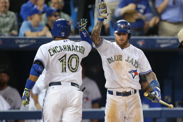Edwin Encarnacion #10 of the Toronto Blue Jays is congratulated by Brett Lawrie #13 after hitting a solo home run in the sixth inning during MLB game action against the Tampa Bay Rays on May 26, 2014 at Rogers Centre in Toronto, Ontario, Canada. (Photo by Tom Szczerbowski/Getty Images).
