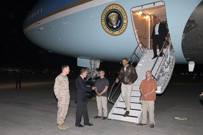 U.S. President Barack Obama is greeted by U.S. Ambassador to Afghanistan James Cunningham, second from left, and Marine General Joseph Dunford, commander of the U.S.-led International Security Assistance Force (ISAF), left, as he steps off Air Force One after arriving at Bagram Air Field for an unannounced visit, on Sunday, May 25, 2014.