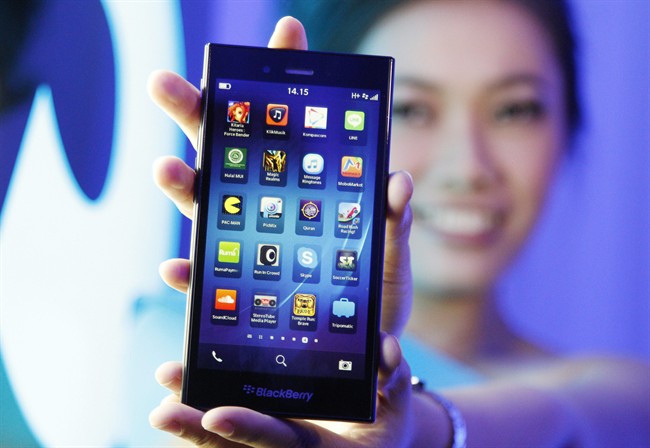 A Blackberry Z3 smartphone is shown by a model during its launch in Jakarta, Indonesia.