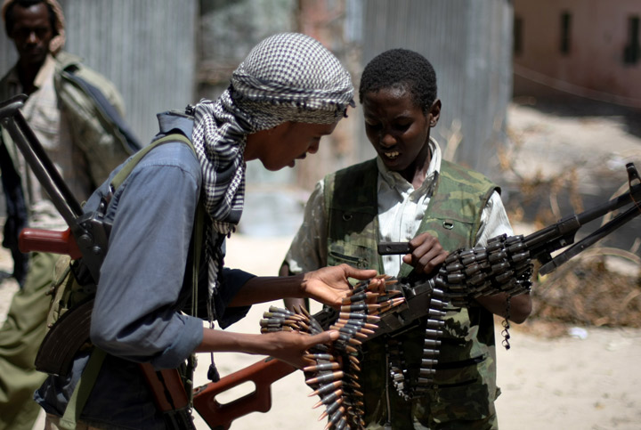Young fighters from Al-Shabab come together to count their bullets at a frontline section in Sinaya Neighborhood in Mogadishu, on July 13, 2009.