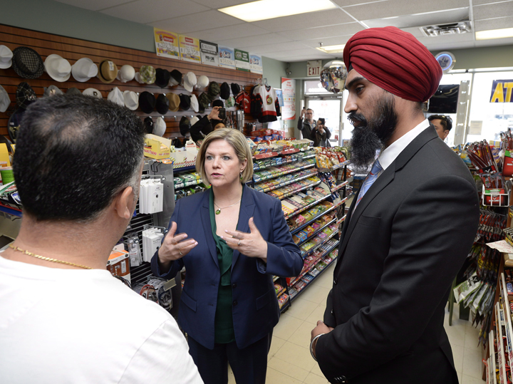 Ont. NDP leader Andrea Horwath speaks with a convenience store owner in Toronto on Monday May 5, 2014.