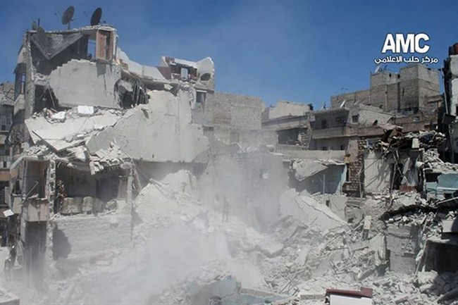 This photo provided by the anti-government activist group Aleppo Media Center (AMC), which has been authenticated based on its contents and other AP reporting, shows buildings which were destroyed from a Syrian government airstrike in Aleppo, Syria, Saturday, May. 17, 2014. 