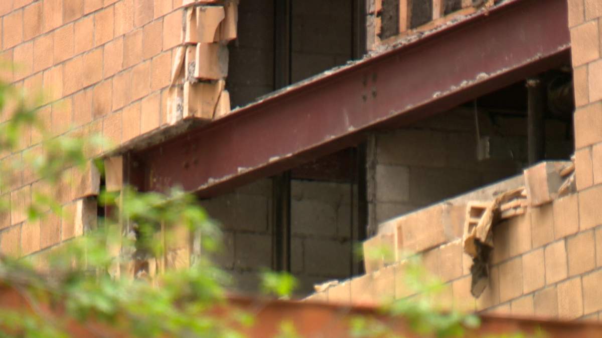 Crews work to repair a crumbling building located in the 600 block of 7th Street S.W.