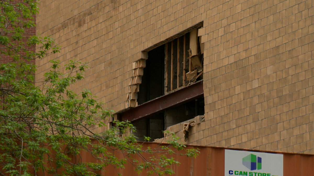Crews work to repair a crumbling building located in the 600 block of 7th Street S.W.