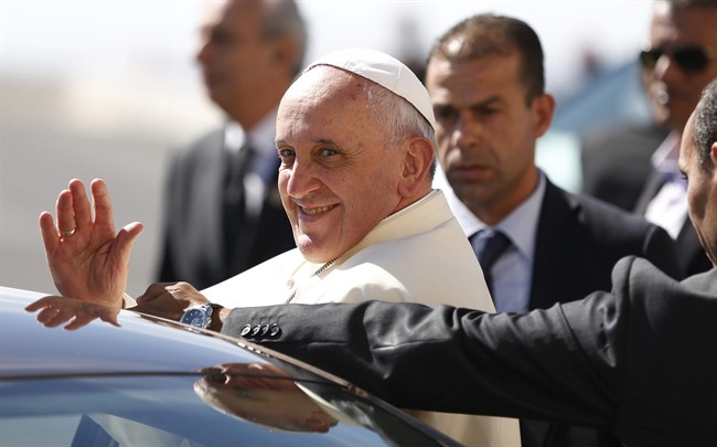 Pope Francis waves upon his arrival at the West Bank town of Bethlehem on Sunday, May 25, 2014. Pope Francis landed Sunday in the West Bank town of Bethlehem in a symbolic nod to Palestinian aspirations for their own state as he began a busy second day of his Mideast pilgrimage. 