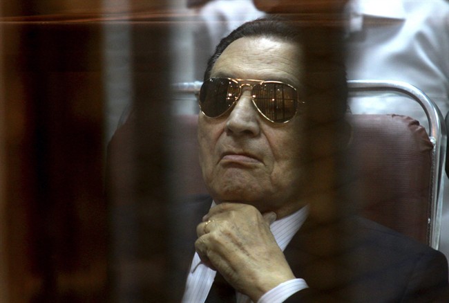 In this Saturday, April 26, 2014 file photo, ousted Egyptian President Hosni Mubarak attends a hearing in his retrial over charges of failing to stop killings of protesters during the 2011 uprising that led to his downfall, in the Police Academy-turned-court in the outskirts of Cairo, Egypt. 