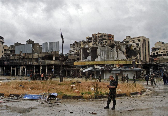 Syrian government forces inspect damages in Homs, Syria.