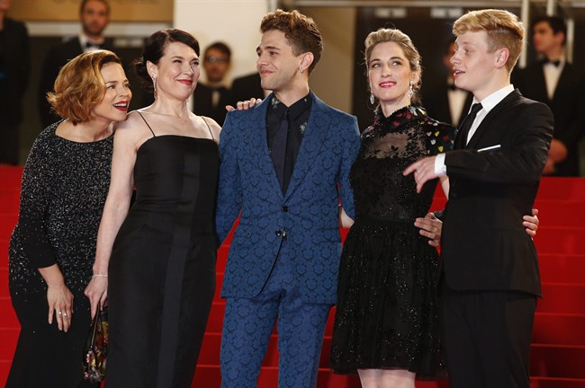 From left, actress Suzanne Clement, actor Antoine-Olivier Pilon, director Xavier Dolan, producer Nancy Grant, and actor Antoine-Olivier Pilon pose for photographers as they arrive for the screening of 'Mommy' at Cannes.