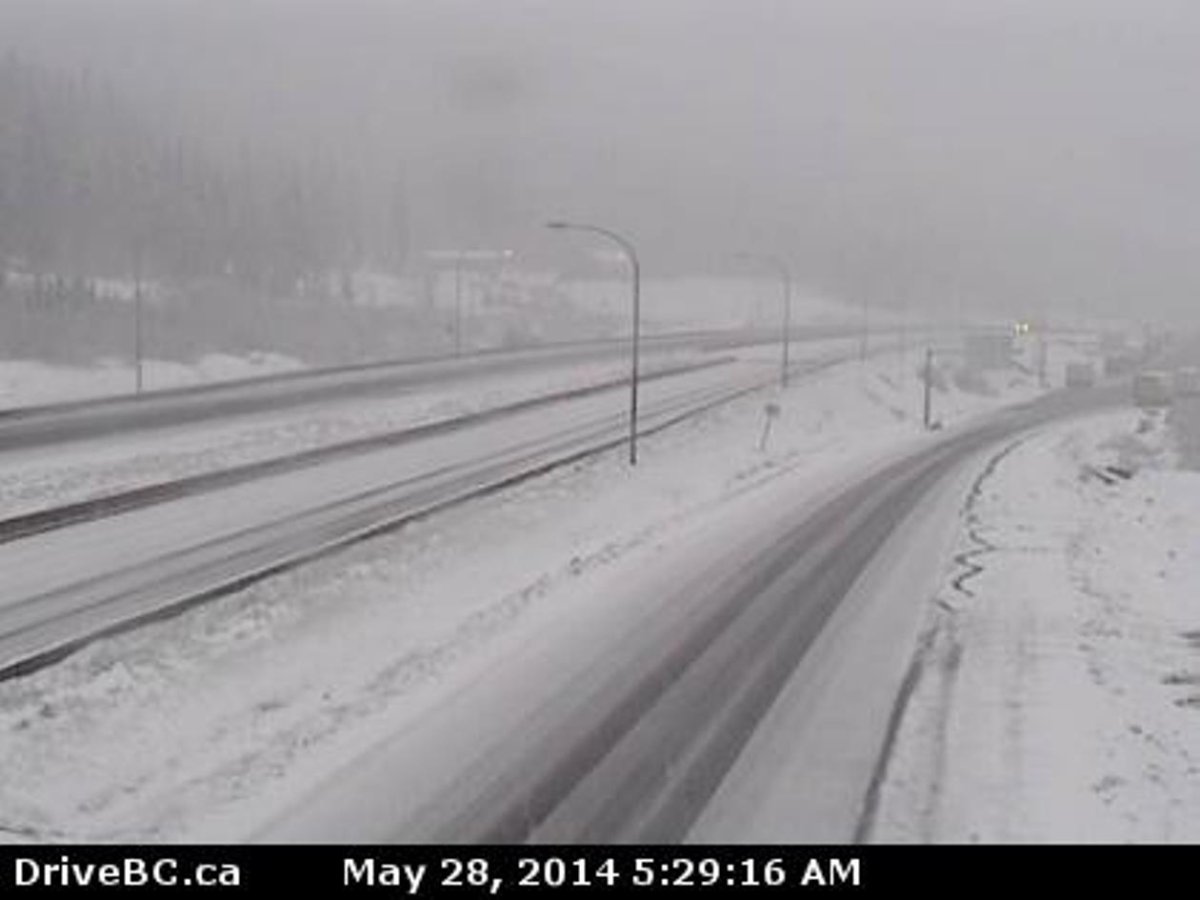 Late May snow is slowing travel on the Coquihalla Highway near the summit. 