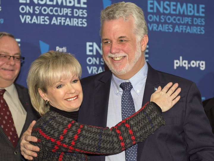 Quebec Liberal Party Leader Philippe Couillard, right, gets a hug from local candidate Julie Boulet on Tuesday, March 11, 2014 in Trois-Rivieres Que. 