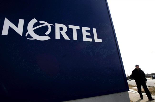 A man walks past a company sign at a Nortel Networks office tower in Toronto on Feb. 25, 2009.