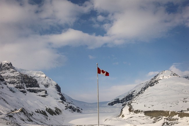 The Canadian flag flies over the Athabasca Glacier part of the Columbia Icefields in Jasper National Park.