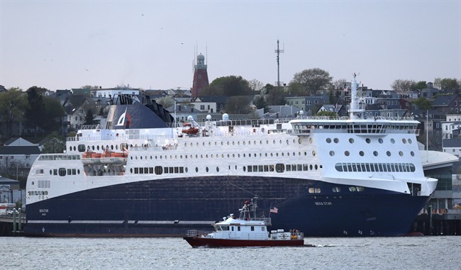 The Nova Star ferry dwarfs the city of Portland's fire boat as it prepares to leave Portland, Maine, May 15, 2014. 