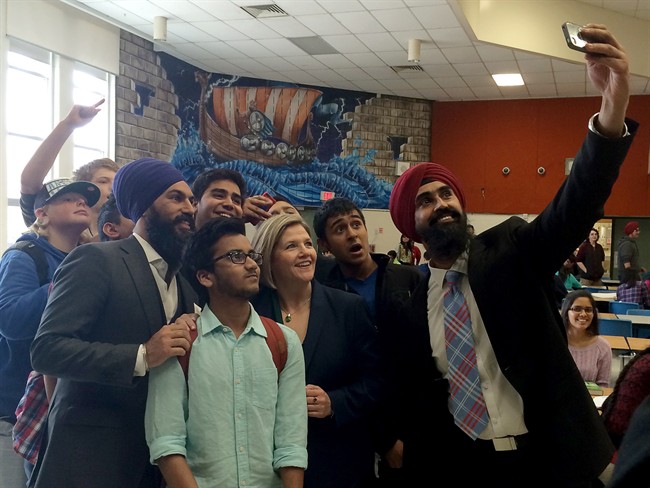 NDP leader Andrea Horwath poses for a "selfie" with NDP candidates Jagmeet Singh (purple turban) and Gurpreet Dhillon (red) and North Park secondary school students in Brampton, Ont. on May 5, 2014.