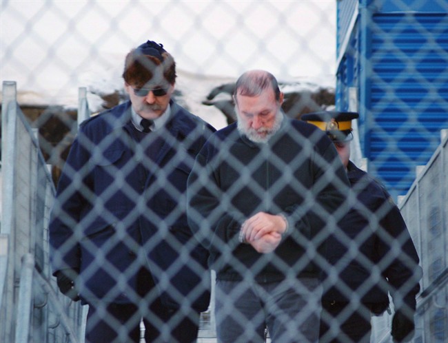 Eric Dejaeger is escorted by police outside an Iqaluit, Nunavut courtroom Jan. 20, 2011.