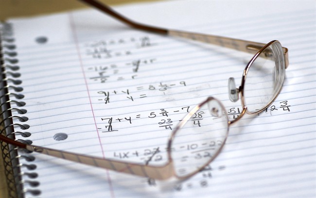 Student's glasses sitting on a notebook containing math exercises are pictured. March 12, 2014.