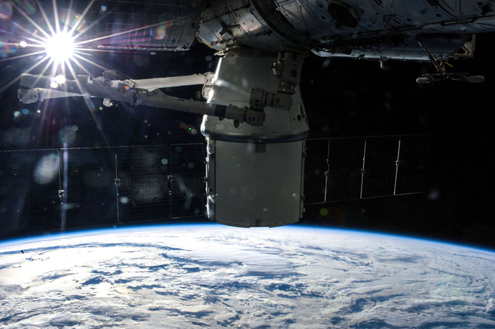 An unmanned Dragon spacecraft docks with the International Space Station.